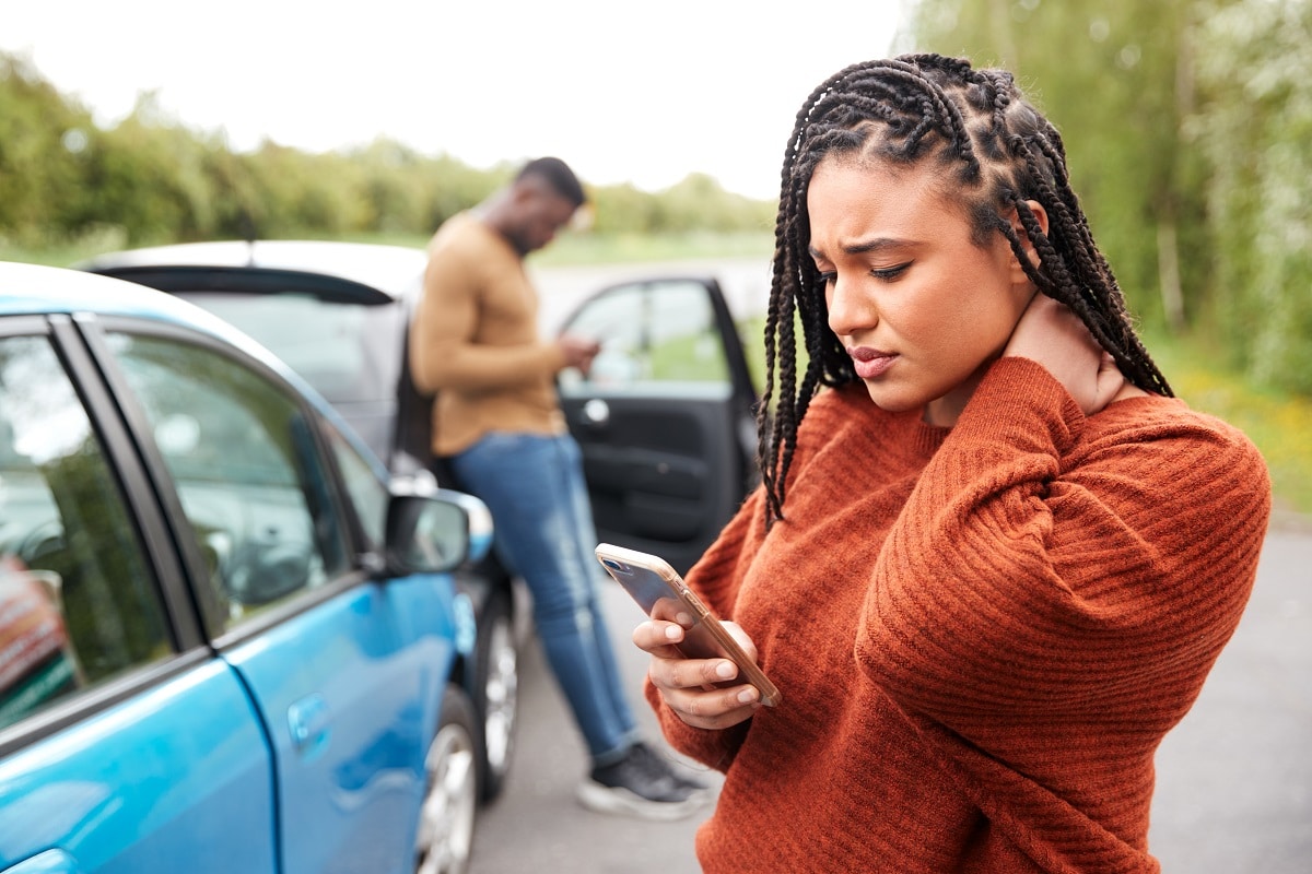 woman holding neck after car accident